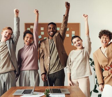 a group of people with their fists up in the air.