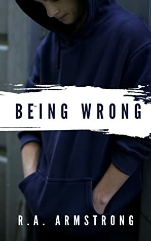 Young person in a dark hoodie stands with hands in pockets against a muted background. Bold text reads "Being Wrong" by R.A. Armstrong.