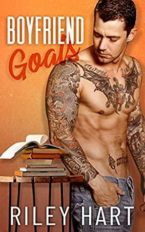 Book cover showing a muscular, tattooed man next to a stack of books. The title "Boyfriend Goals" is in bold white and red text. The tone is bold and confident.