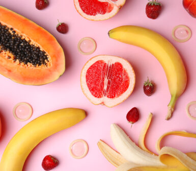 Flat lay composition with exotic fruits on pink background.