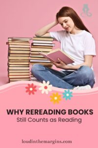 Young woman reads a book beside tall stacks of books on a pink background, with flowers and text: “Why rereading books still counts as reading.”